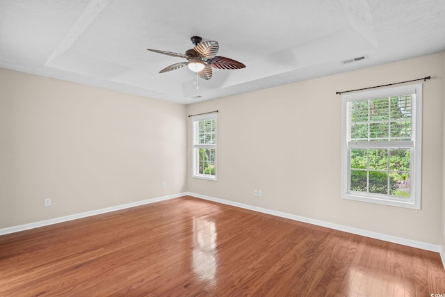 5008 Hayes Bay Ct, Murrells Inlet, SC 29576 - empty room featuring a raised ceiling, wood finished floors, and ceiling fan