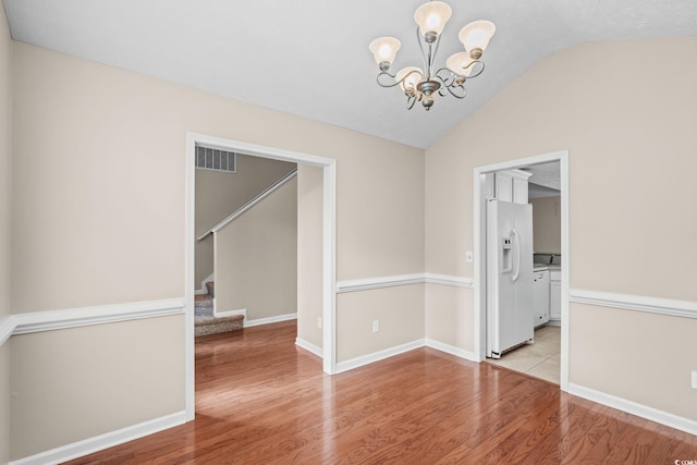 5008 Hayes Bay Ct, Murrells Inlet, SC 29576 - spare room with a chandelier, light wood-style floors, lofted ceiling, and stairs