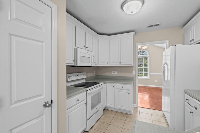 5008 Hayes Bay Ct, Murrells Inlet, SC 29576 - kitchen featuring white appliances, white cabinets, light tile patterned flooring, and light countertops