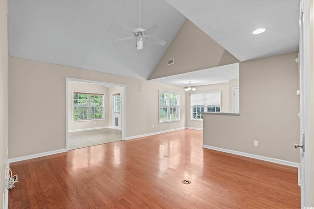 5008 Hayes Bay Ct, Murrells Inlet, SC 29576 - unfurnished living room featuring a chandelier, a ceiling fan, wood finished floors, and high vaulted ceiling