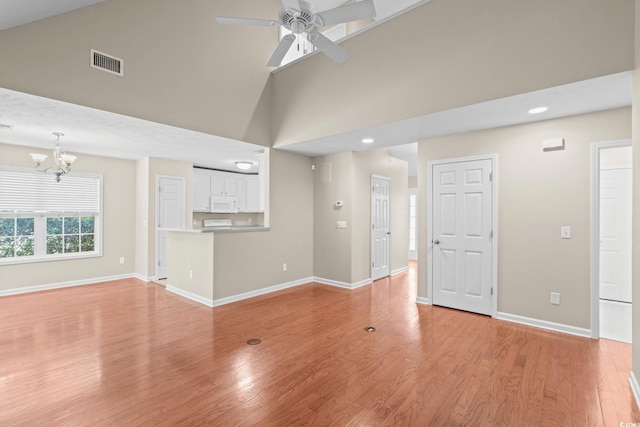 5008 Hayes Bay Ct, Murrells Inlet, SC 29576 - unfurnished living room featuring a chandelier, high vaulted ceiling, a ceiling fan, light wood-style flooring, and recessed lighting