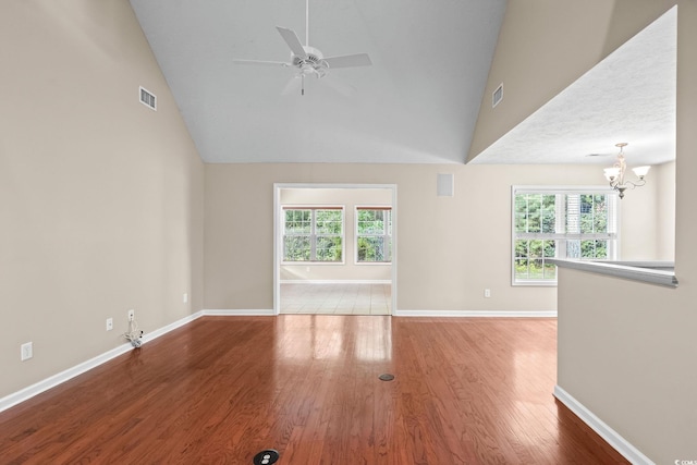 5008 Hayes Bay Ct, Murrells Inlet, SC 29576 - unfurnished living room featuring a chandelier, wood finished floors, plenty of natural light, ceiling fan, and high vaulted ceiling