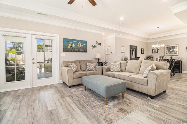 800 Monarch Dr Unit 49, Myrtle Beach, SC 29588 - living room with light wood-style flooring, a chandelier, ceiling fan, a tray ceiling, and ornamental molding