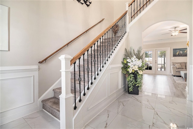 800 Monarch Dr Unit 49, Myrtle Beach, SC 29588 - staircase featuring marble finish floors, ceiling fan, arched walkways, and french doors