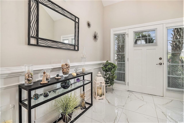 800 Monarch Dr Unit 49, Myrtle Beach, SC 29588 - entrance foyer featuring a wainscoted wall, marble look tiles, and a decorative wall