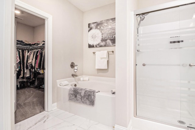 800 Monarch Dr Unit 49, Myrtle Beach, SC 29588 - full bath featuring a stall shower, a garden tub, a walk in closet, and marble finish floors