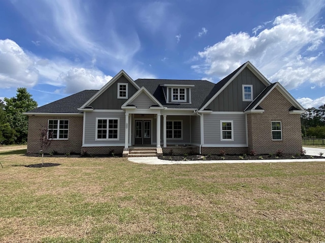140 Pottery Landing Dr, Conway, SC 29527 - craftsman-style house with board and batten siding, a front yard, brick siding, and a shingled roof