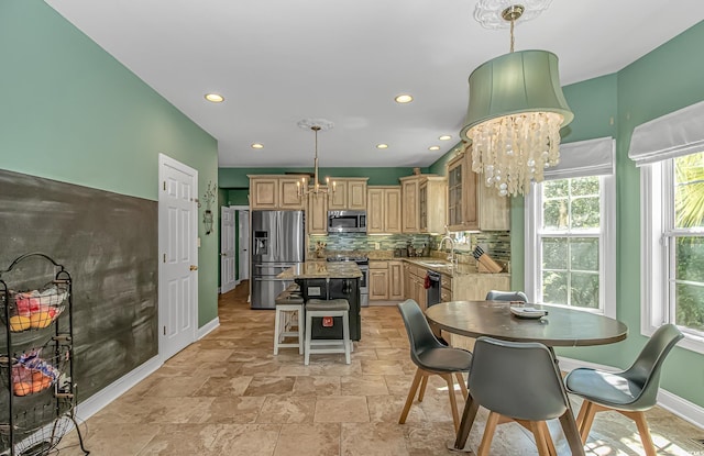 1176 Old Plantation Dr, Pawleys Island, SC 29585 - dining area featuring a chandelier, healthy amount of natural light, recessed lighting, and light stone finish floors