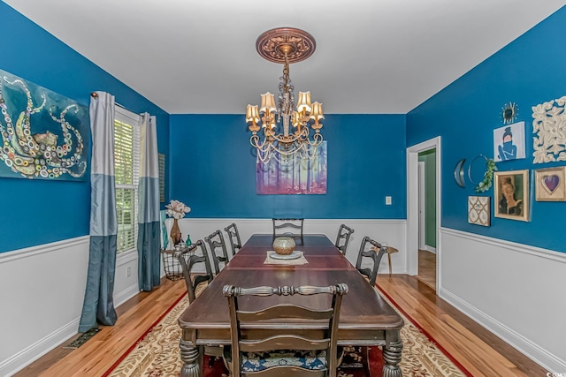 1176 Old Plantation Dr, Pawleys Island, SC 29585 - dining space featuring a chandelier and wood finished floors