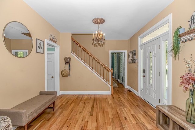 1176 Old Plantation Dr, Pawleys Island, SC 29585 - foyer entrance with stairs, a chandelier, and light wood finished floors