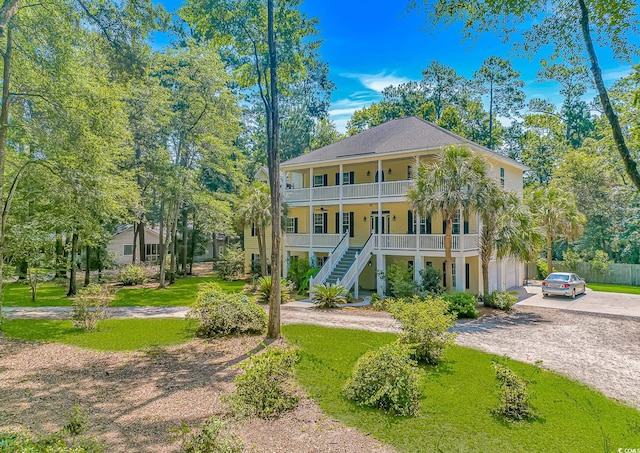 1176 Old Plantation Dr, Pawleys Island, SC 29585 - coastal home with a porch, driveway, stairway, and a front yard