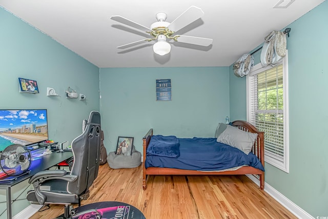 1176 Old Plantation Dr, Pawleys Island, SC 29585 - bedroom with wood finished floors, an office area, and ceiling fan