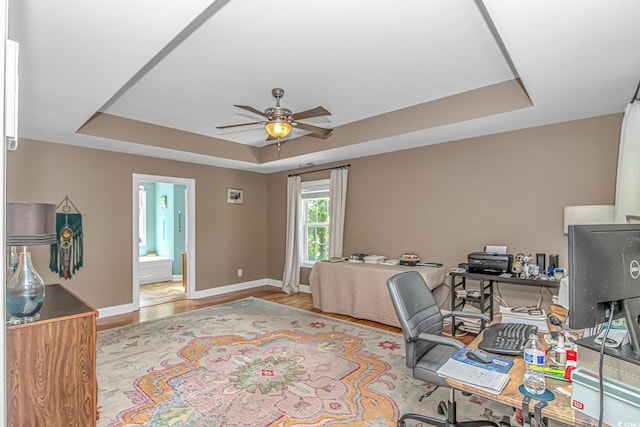 1176 Old Plantation Dr, Pawleys Island, SC 29585 - home office with a raised ceiling, ceiling fan, and wood finished floors