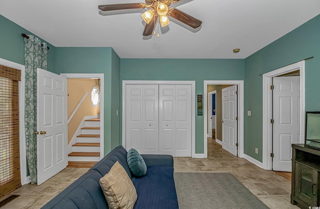 1176 Old Plantation Dr, Pawleys Island, SC 29585 - living room with a ceiling fan, stairs, and stone tile floors