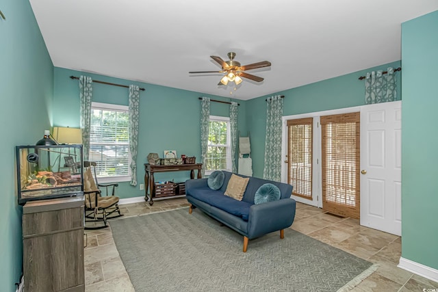 1176 Old Plantation Dr, Pawleys Island, SC 29585 - living area featuring plenty of natural light, stone tile flooring, and a ceiling fan