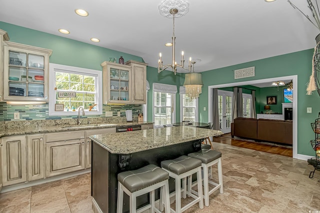 1176 Old Plantation Dr, Pawleys Island, SC 29585 - kitchen featuring a chandelier, plenty of natural light, cream cabinets, tasteful backsplash, and recessed lighting