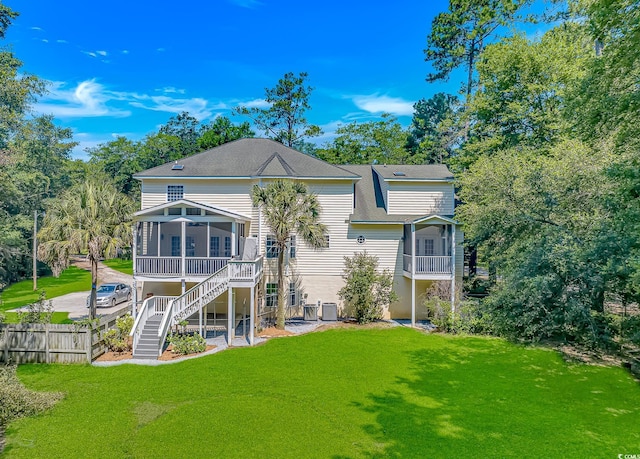 1176 Old Plantation Dr, Pawleys Island, SC 29585 - rear view of house featuring a sunroom, stairs, a shingled roof, and view of wooded area
