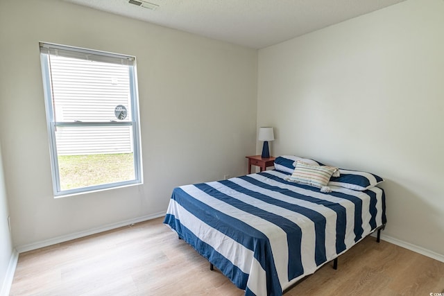 805 Cherry Bark Ct, Myrtle Beach, SC 29579 - bedroom featuring wood finished floors and multiple windows
