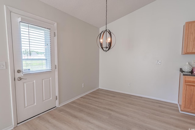 805 Cherry Bark Ct, Myrtle Beach, SC 29579 - unfurnished dining area with a chandelier, light wood-style flooring, and a textured ceiling