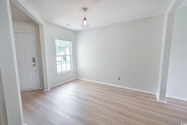 805 Cherry Bark Ct, Myrtle Beach, SC 29579 - unfurnished dining area featuring light wood finished floors and a textured ceiling