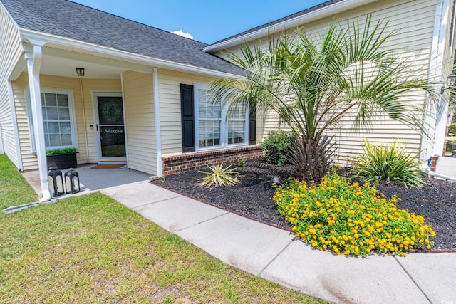 805 Cherry Bark Ct, Myrtle Beach, SC 29579 - entrance to property featuring brick siding, roof with shingles, a lawn, and covered porch
