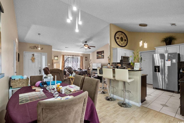 2611 Ringneck Trl, Myrtle Beach, SC 29588 - dining space with lofted ceiling, a ceiling fan, light wood-style flooring, and a textured ceiling