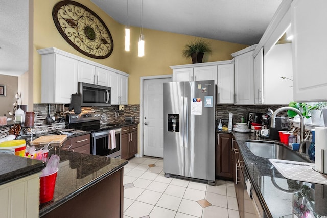 2611 Ringneck Trl, Myrtle Beach, SC 29588 - kitchen with appliances with stainless steel finishes, backsplash, decorative light fixtures, dark stone countertops, and high vaulted ceiling