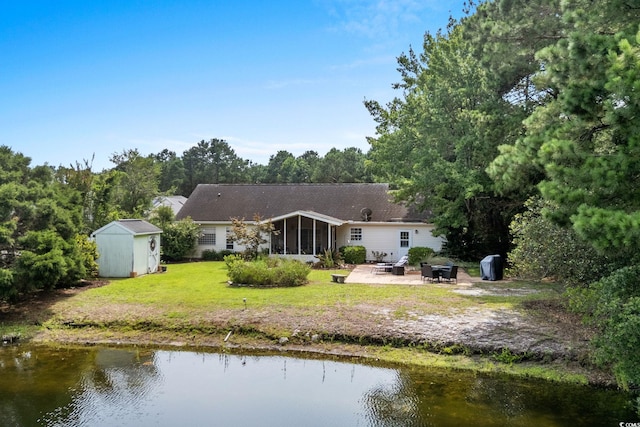 2611 Ringneck Trl, Myrtle Beach, SC 29588 - rear view of property with a patio area, a sunroom, a storage unit, a yard, and a water view