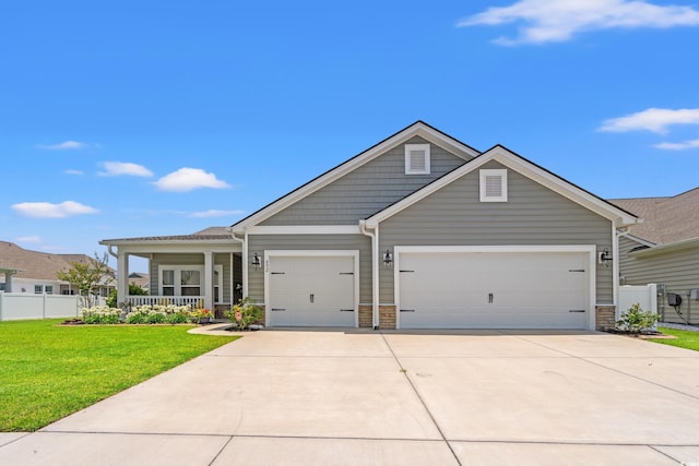 892 Harrison Mill St, Myrtle Beach, SC 29579 - view of front facade with an attached garage, driveway, covered porch, and stone siding