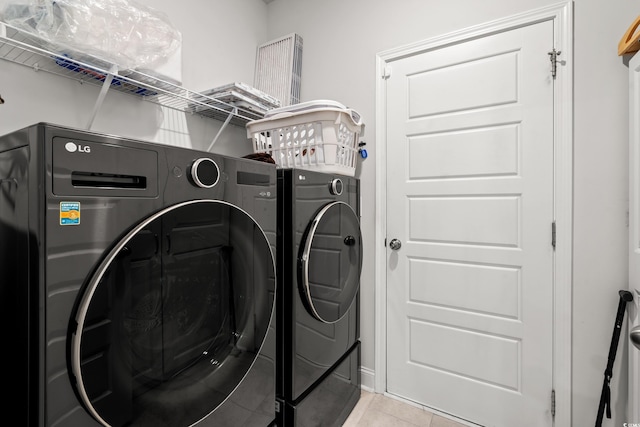 892 Harrison Mill St, Myrtle Beach, SC 29579 - laundry area with washer and dryer and light tile patterned floors