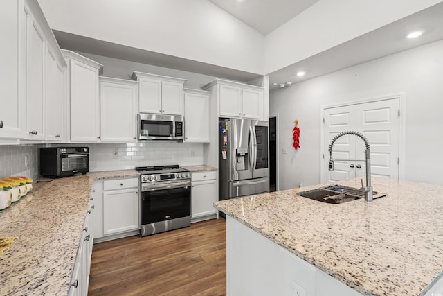 892 Harrison Mill St, Myrtle Beach, SC 29579 - kitchen with stainless steel appliances, white cabinetry, backsplash, high vaulted ceiling, and recessed lighting