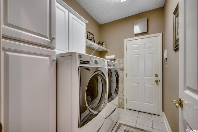 911 Tilghman Forest Dr, North Myrtle Beach, SC 29582 - laundry area with washing machine and clothes dryer, light tile patterned floors, cabinet space, and a textured ceiling