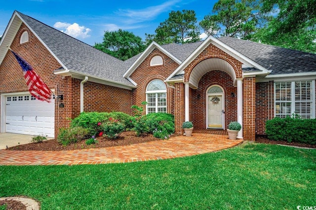 911 Tilghman Forest Dr, North Myrtle Beach, SC 29582 - traditional-style house with brick siding, roof with shingles, an attached garage, and a front yard