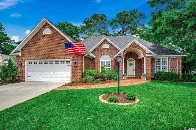 911 Tilghman Forest Dr, North Myrtle Beach, SC 29582 - traditional-style house featuring brick siding, a front lawn, driveway, and a garage