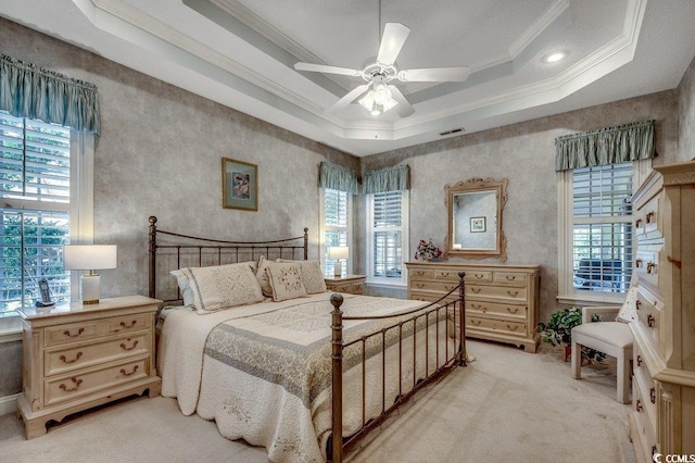 911 Tilghman Forest Dr, North Myrtle Beach, SC 29582 - bedroom featuring ornamental molding, multiple windows, light colored carpet, a raised ceiling, and ceiling fan