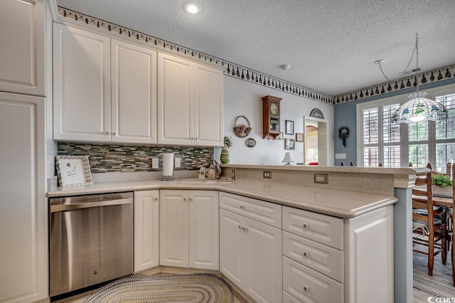 911 Tilghman Forest Dr, North Myrtle Beach, SC 29582 - kitchen featuring stainless steel dishwasher, a textured ceiling, a peninsula, white cabinets, and light countertops