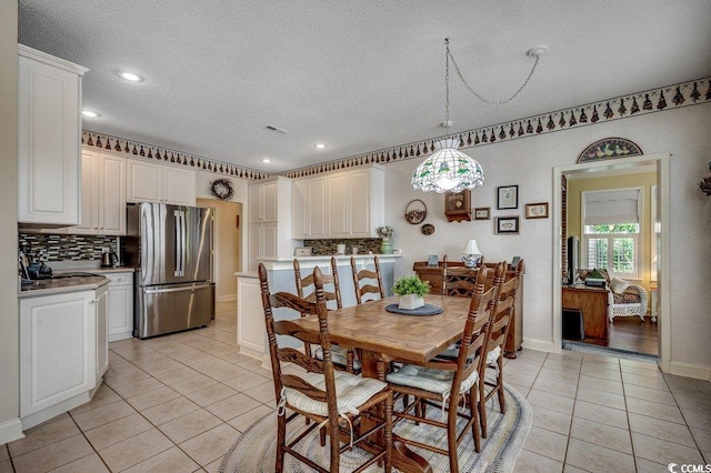 911 Tilghman Forest Dr, North Myrtle Beach, SC 29582 - dining space featuring light tile patterned floors, a textured ceiling, and recessed lighting