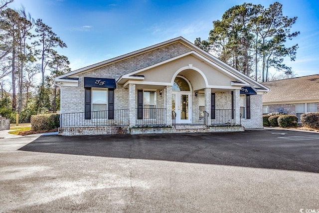 911 Tilghman Forest Dr, North Myrtle Beach, SC 29582 - view of front of home featuring brick siding and a porch