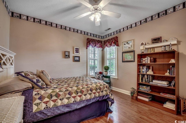 911 Tilghman Forest Dr, North Myrtle Beach, SC 29582 - bedroom with wood finished floors, a textured ceiling, and a ceiling fan