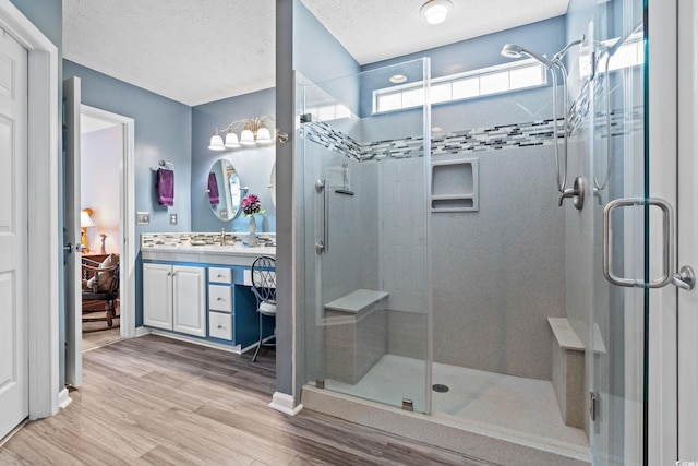 2783 Sanctuary Blvd, Conway, SC 29526 - bathroom featuring vanity, a stall shower, wood finished floors, and a textured ceiling