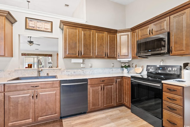 2783 Sanctuary Blvd, Conway, SC 29526 - kitchen featuring black range with electric stovetop, stainless steel microwave, dishwasher, light countertops, and light wood finished floors