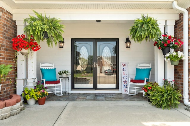 5904 Bridlewood Rd, North Myrtle Beach, SC 29582 - view of exterior entry with french doors, brick siding, and a porch