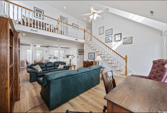 30462NDAVE N 62nd Ave N, North Myrtle Beach, SC 29582 - living room with a ceiling fan, stairs, light wood-style floors, and high vaulted ceiling