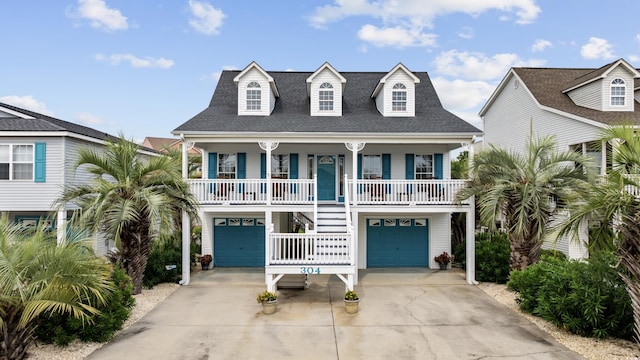 30462NDAVE N 62nd Ave N, North Myrtle Beach, SC 29582 - coastal home featuring a porch, stairs, driveway, and a garage