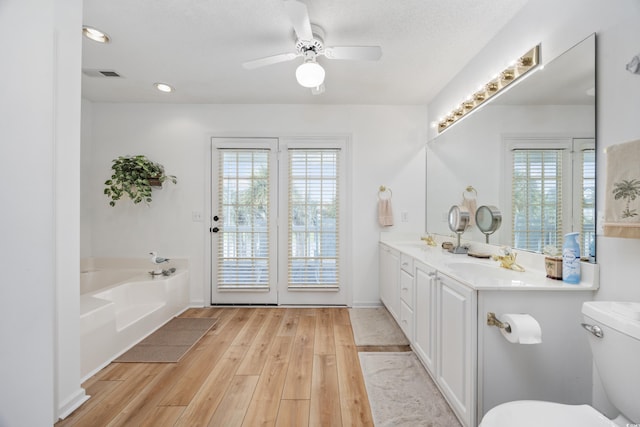 30462NDAVE N 62nd Ave N, North Myrtle Beach, SC 29582 - bathroom with wood finished floors, double vanity, a garden tub, ceiling fan, and recessed lighting
