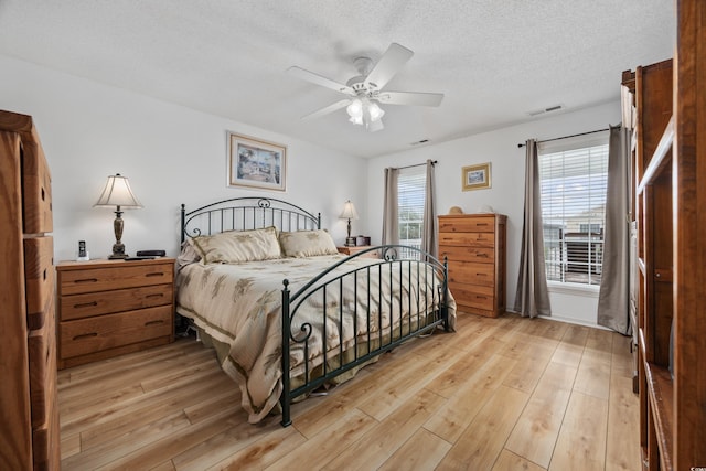 30462NDAVE N 62nd Ave N, North Myrtle Beach, SC 29582 - bedroom featuring light wood-style floors, a textured ceiling, and ceiling fan