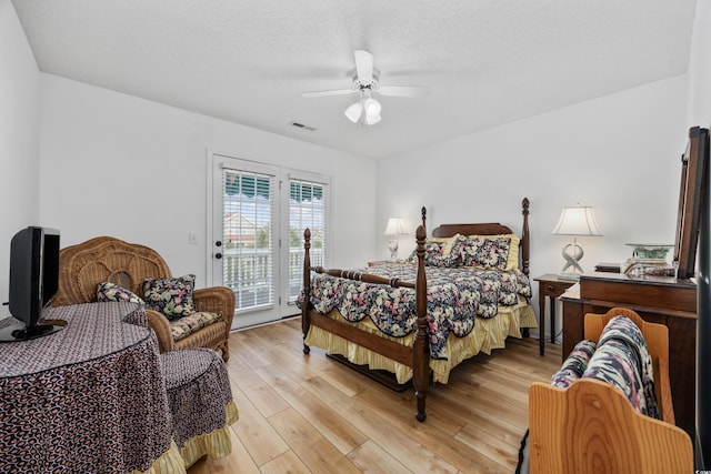 30462NDAVE N 62nd Ave N, North Myrtle Beach, SC 29582 - bedroom with access to exterior, light wood-type flooring, ceiling fan, and a textured ceiling