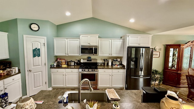1300 Ruddy Ct, Conway, SC 29527 - kitchen featuring appliances with stainless steel finishes, lofted ceiling, dark countertops, and white cabinetry