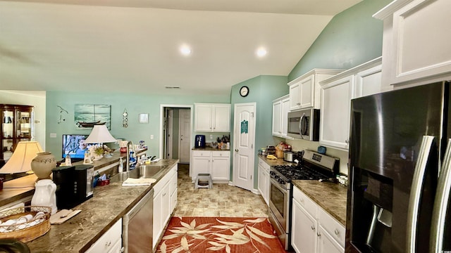 1300 Ruddy Ct, Conway, SC 29527 - kitchen with stainless steel appliances, white cabinetry, lofted ceiling, and dark countertops
