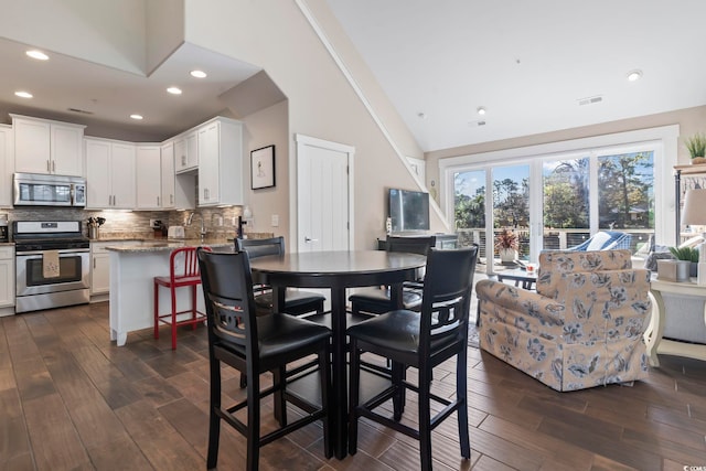 6624 Lagoon Pl, Myrtle Beach, SC 29572 - dining room with dark wood finished floors, vaulted ceiling, and recessed lighting